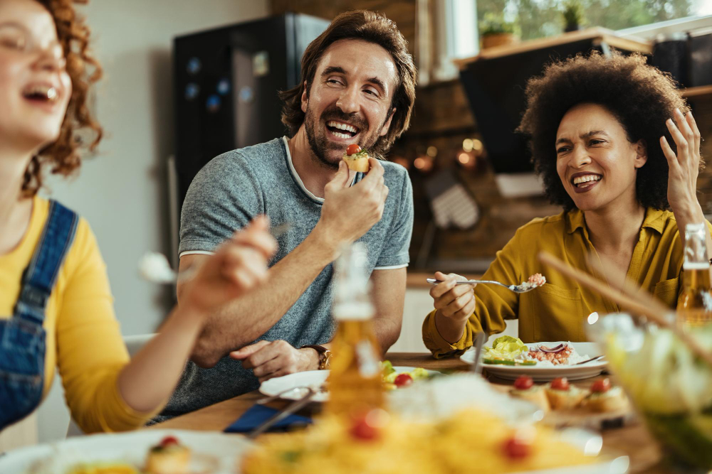 small-group-young-happy-people-enjoying-lunch-while-talking-each-other-dining-table